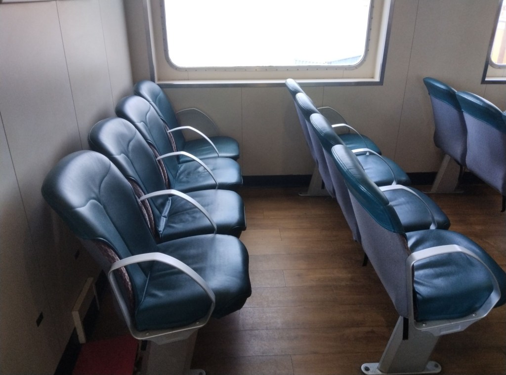 Onboard four abreast seating on MV Bute with a window in the background